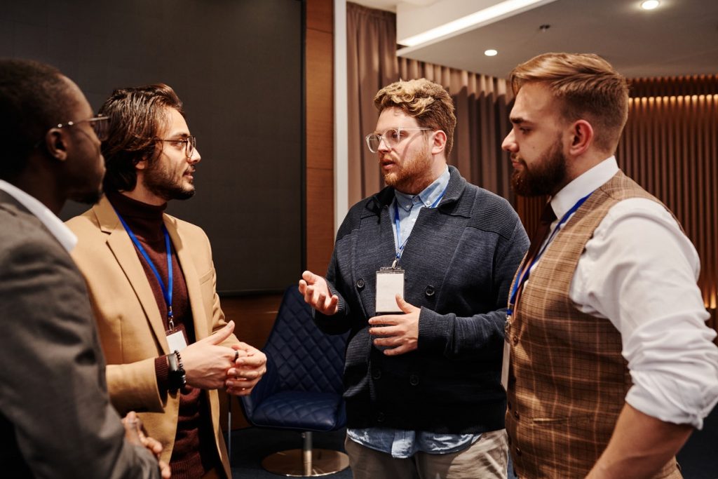 Four attendees at a trade show immersed in a conversation.